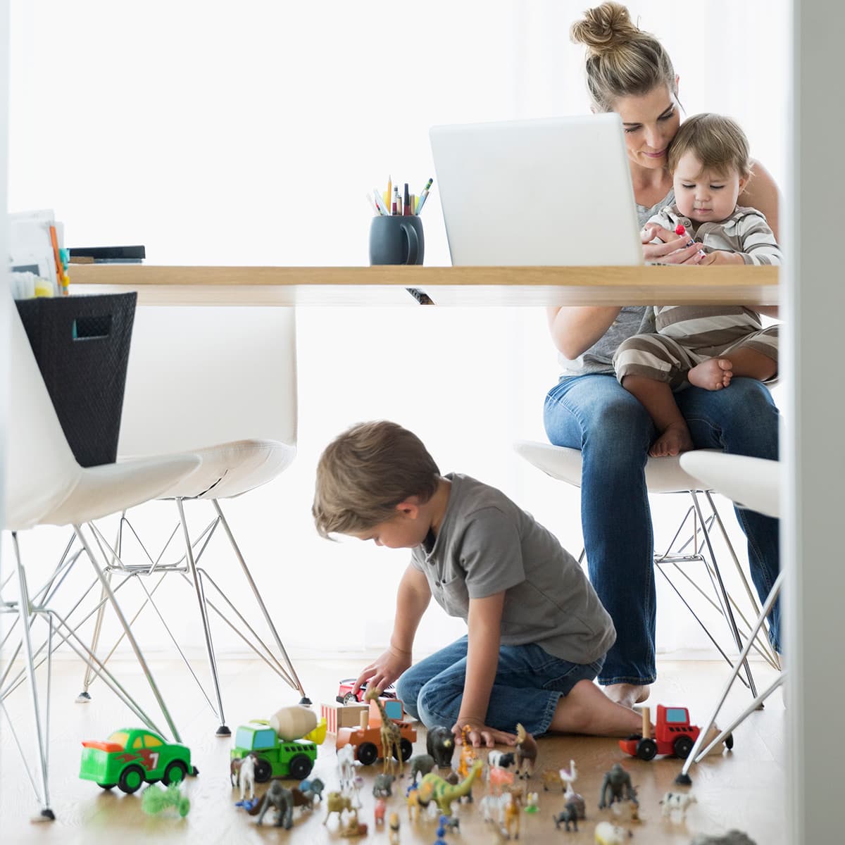 Working mom with kids at laptop.