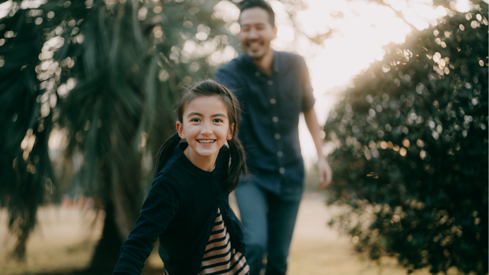 Girl and dad running outside