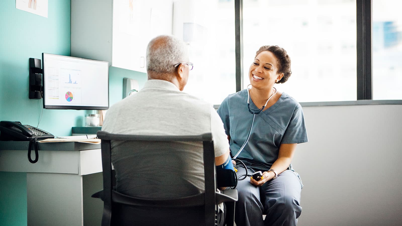 Patient-talks-with-doctor-in-exam-room