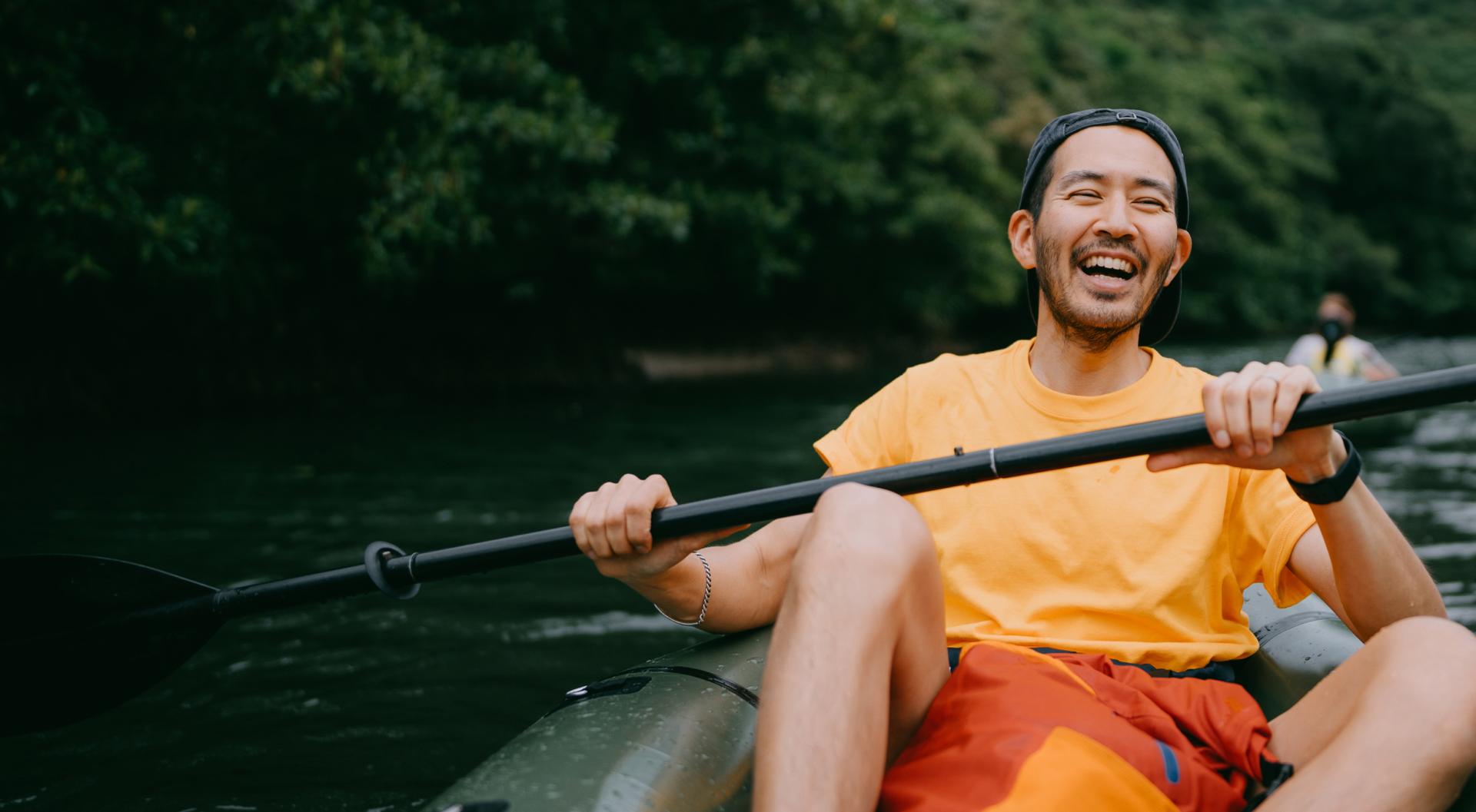 Happy man kayaking down a river Happy man kayaking down a river