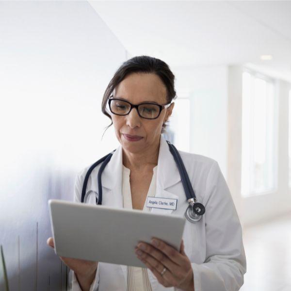 Female doctor reviewing patient chart .