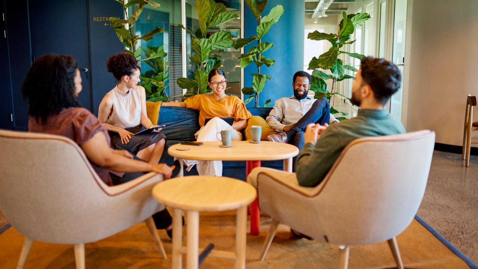 People smiling cheerfully at team meeting