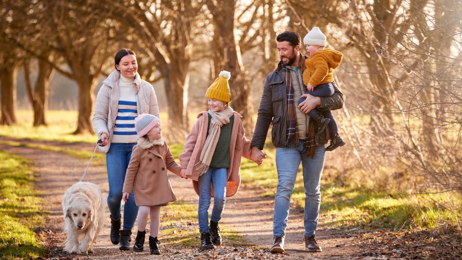 family-walking-with-pet-dog-1600x900
