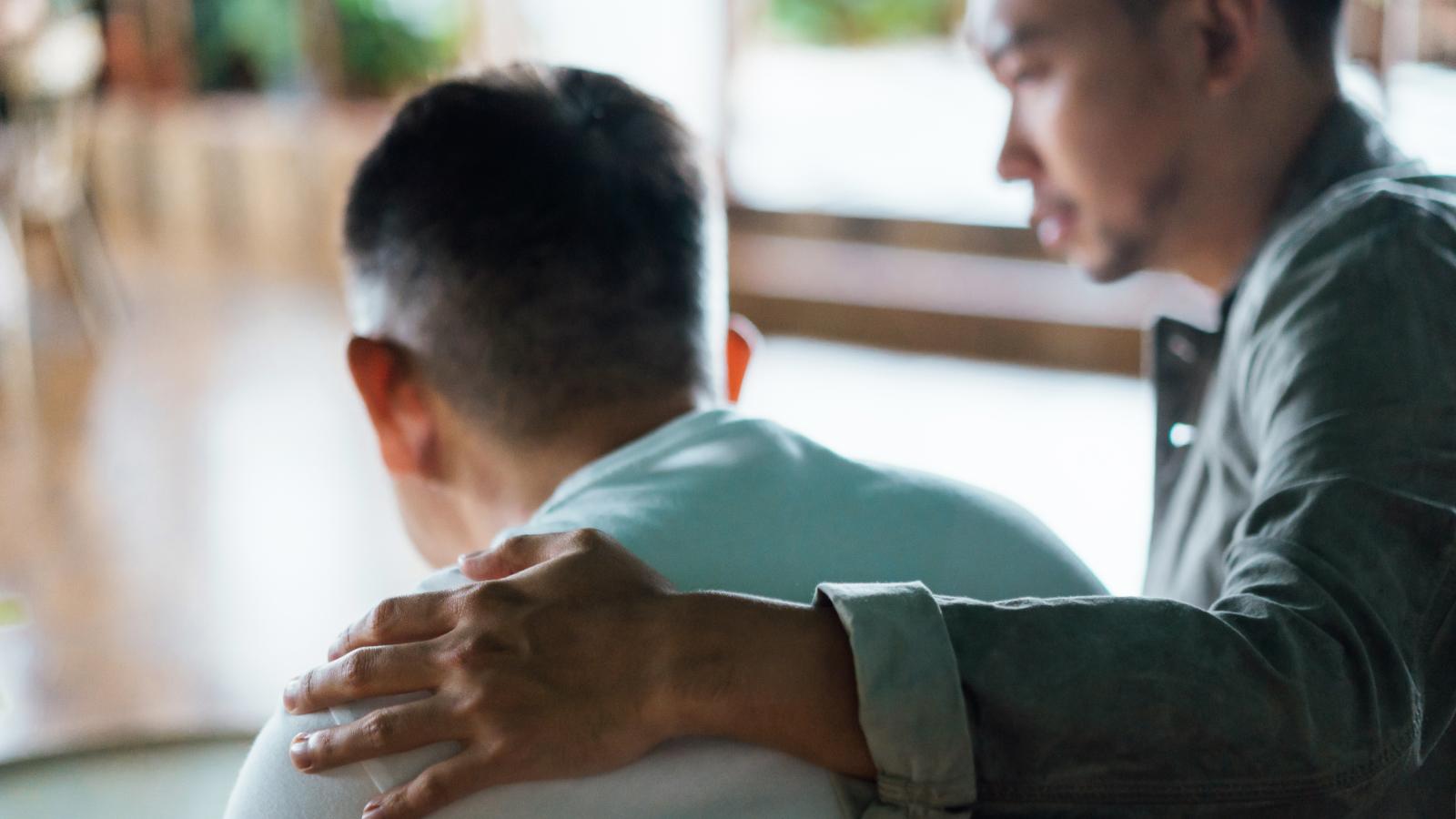Man supporting another person
