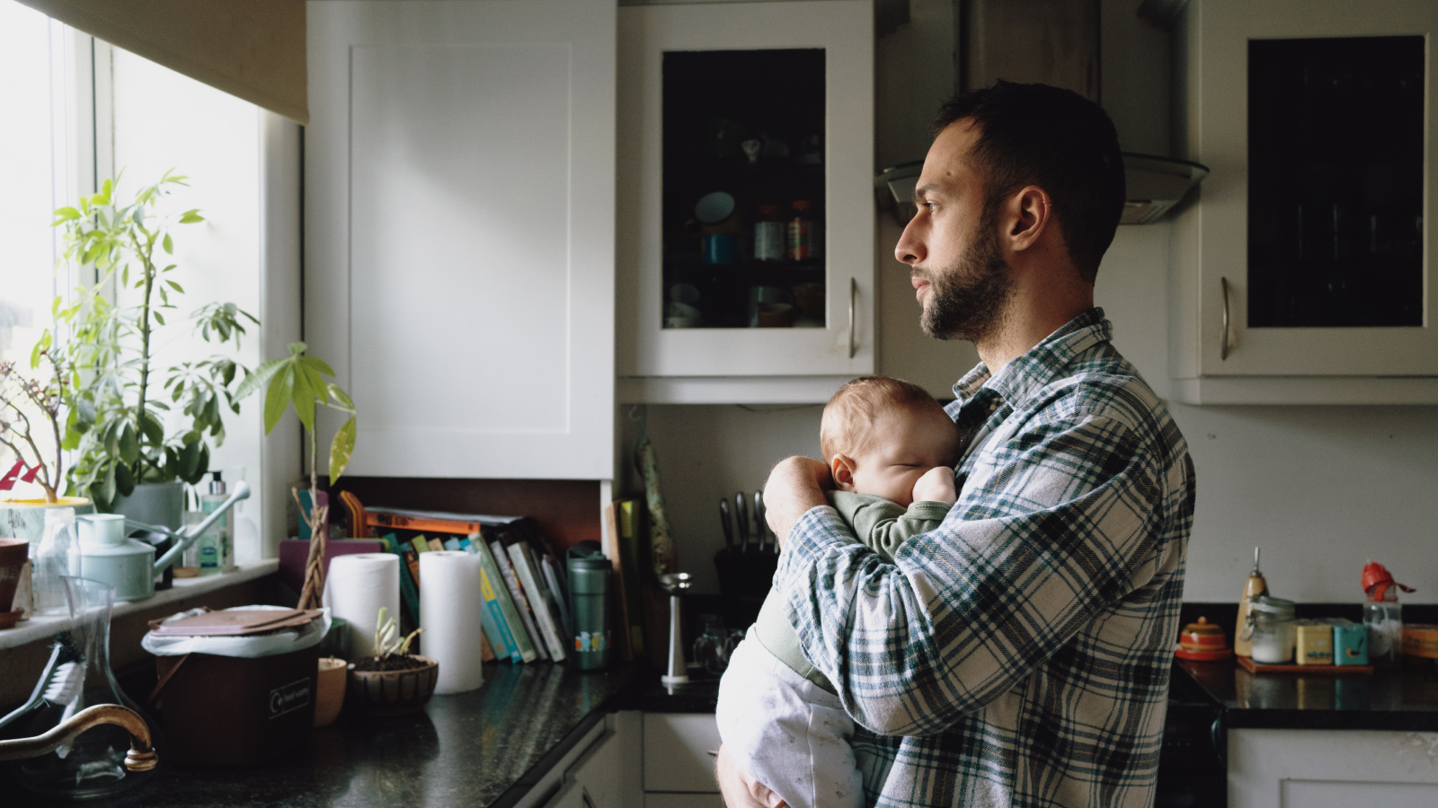 Dad at home holds newborn